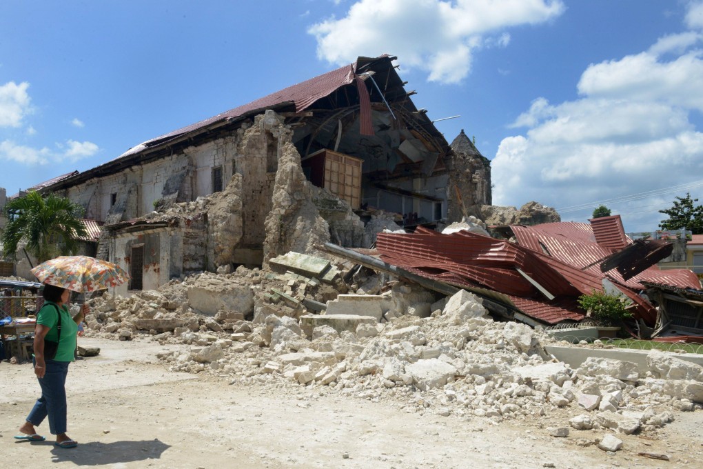 A Philippine pedestrian passes the ruins of the historic Loboc Church in Loboc town on the central Philippine island of Bohol. Photo: AFP