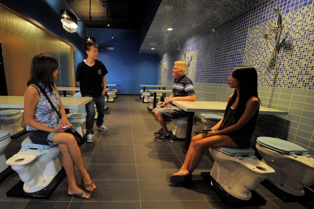 Diners sit on toilet seats at the Magic Restroom. Photo: AFP