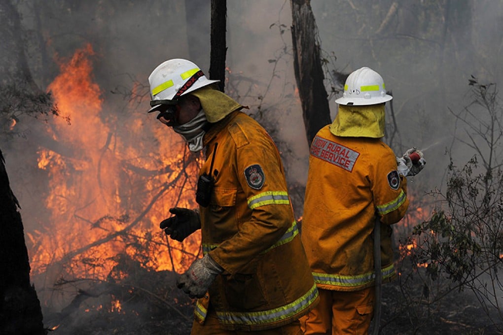 New South Wales Rural Fire Service crews protect a property on Bulgamatta Road in the township of Berambing in the Blue Mountains, west of Sydney, Australia, on Tuesday. Photo: EPA