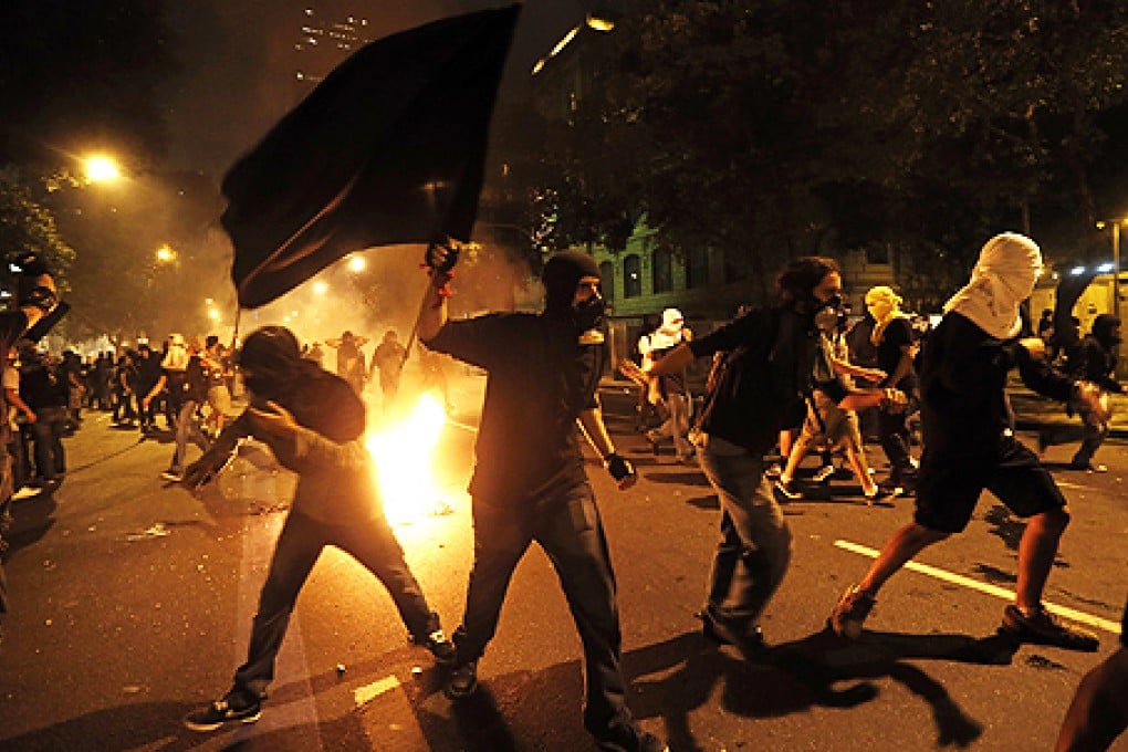 Masked members of the so-called Black Bloc anarchist group in Rio de Janeiro. Photo: AP