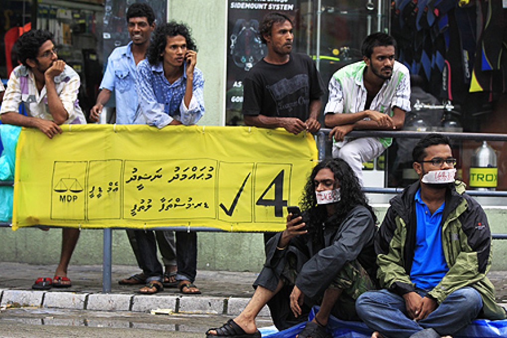 Supporters of Maldives former president Mohamed Nasheed with their mouths covered during a silent protest in Male on Monday. Photo: AP