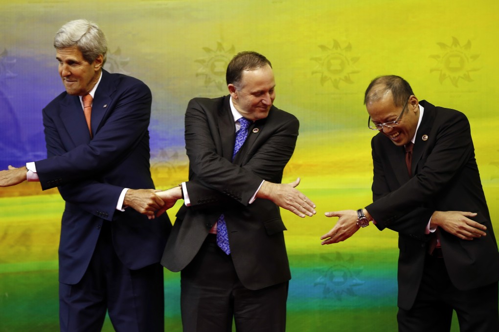 US Secretary of State John Kerry, New Zealand's Prime Minister John Key and Philippine President Benigno Aquino join hands at the Asean Summit. Photo: AP