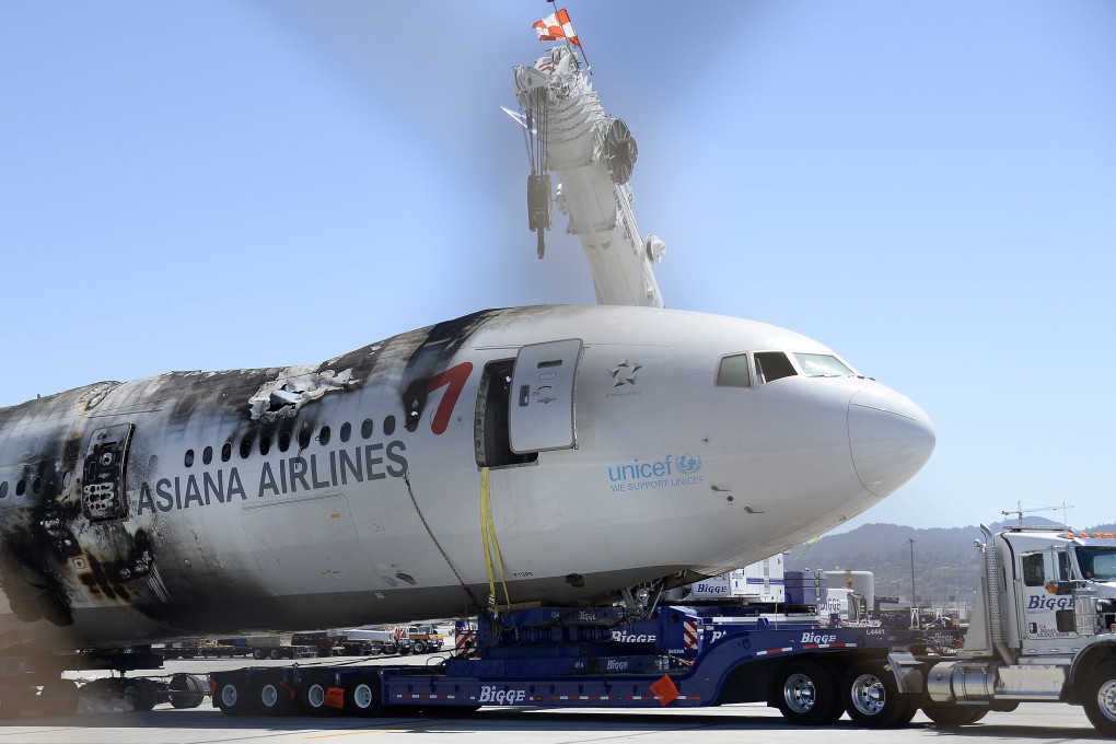 The wreckage of the Asiana Airlines Flight 214 is moved off the runway at San Francisco International Airport. Photo: EPA