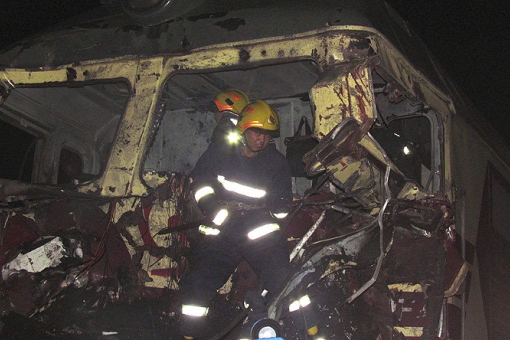 Rescue workers search a damaged train after it crashed into a truck loaded with coal in Jiamusi, Heilongjiang province, on Thursday. Photo: Reuters