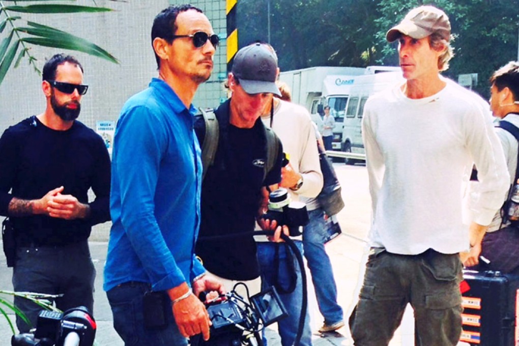 Michael Bay, director of Transformers 4, continues shooting in Quarry Bay. A suspected triad member was in police custody tonight after being arrested on suspicion of extorting money from the filming crew in To Kwa Wan. Photo: SCMP