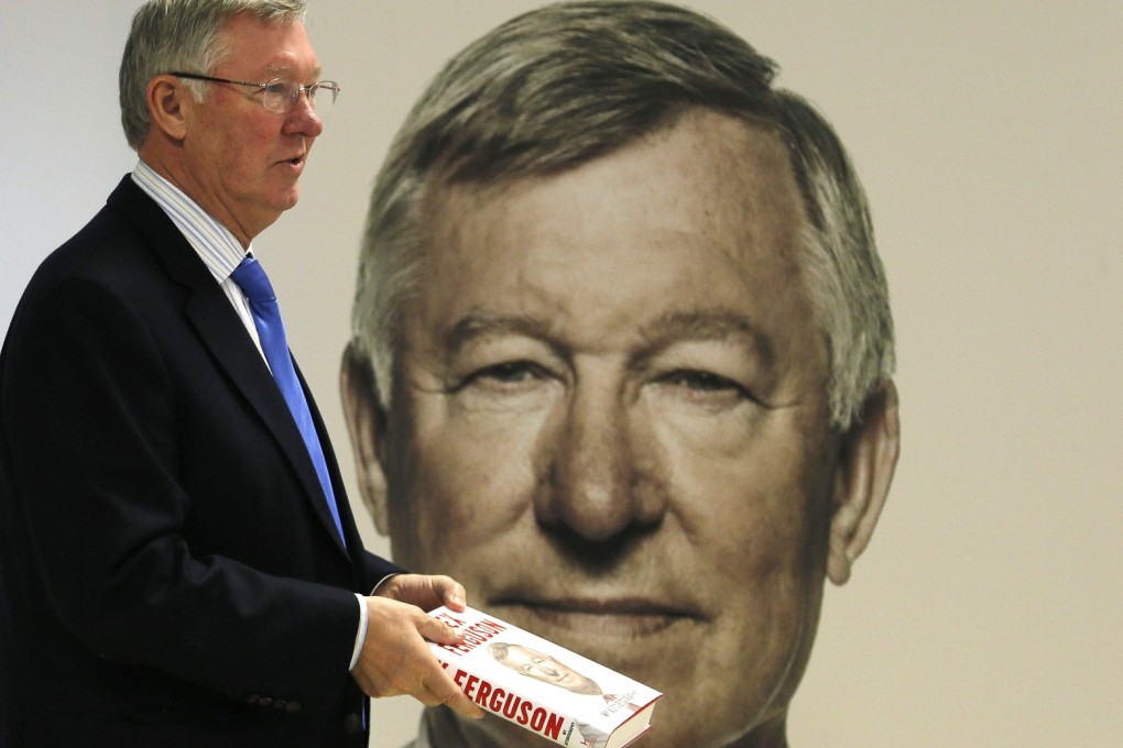 Alex Ferguson poses with his new autobiography before a book signing in Manchester. Photo: Reuters