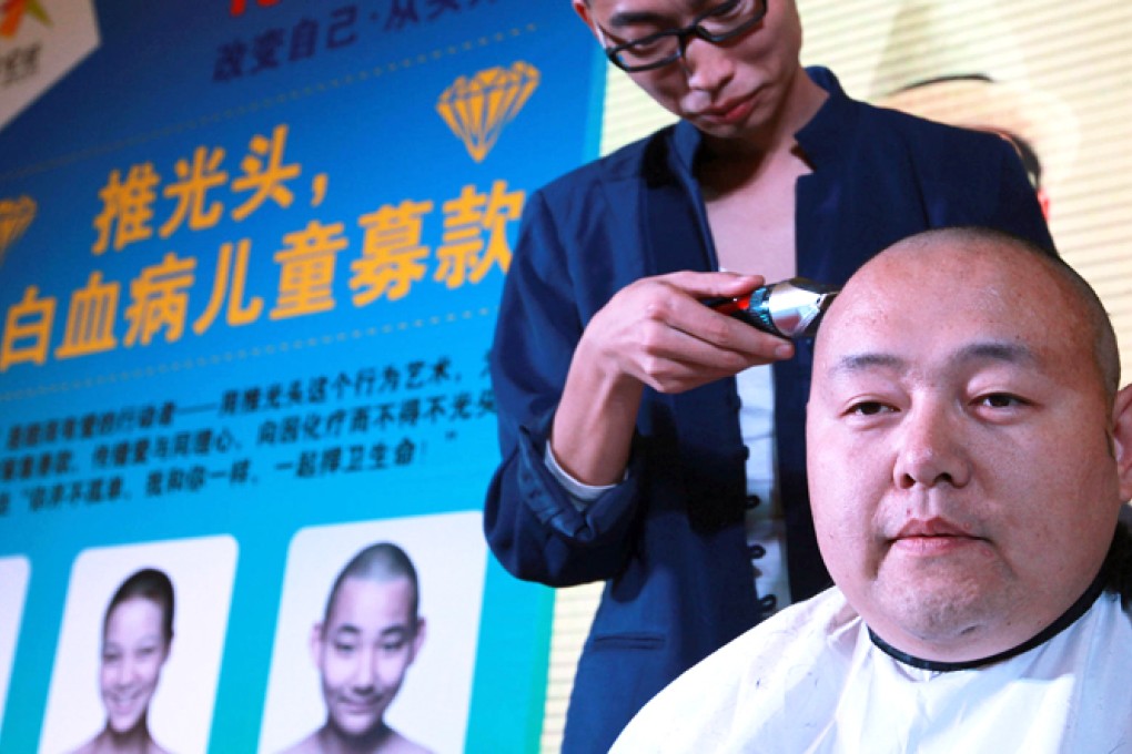 Head shaving for charity at a Shining Star Foundation event in Beijing. Photo: Simon Song