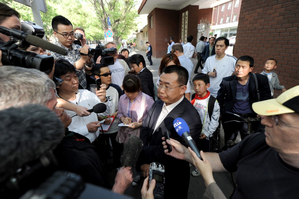 Journalists interview rights lawyer Jiang Tianyong in May of last year outside the hospital in Beijing where blind activist  Chen Guangcheng was receiving medical attention after escaping house arrest. Jiang was detained and beaten by police two days after the picture was taken. Photos: AFP; Reporters Sans Frontieres; Jim Watson; Mark Ralston; STR