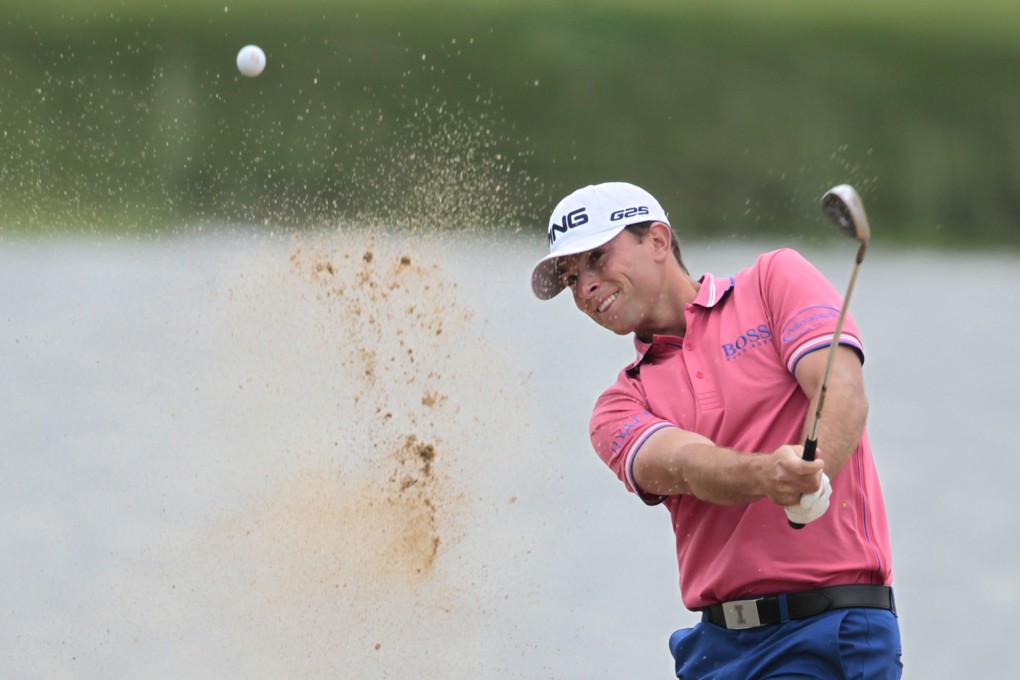 Luke Guthrie of the United States hits out of a bunker during the second round of the BMW Masters in Shanghai. Photo: AP