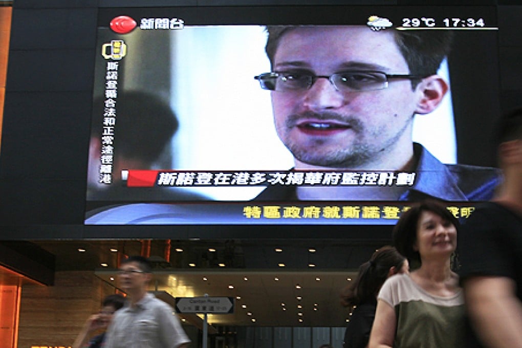 A TV screen shows Edward Snowden, the former CIA contractor who leaked top-secret documents, at a Hong Kong shopping mall. Photo: AP