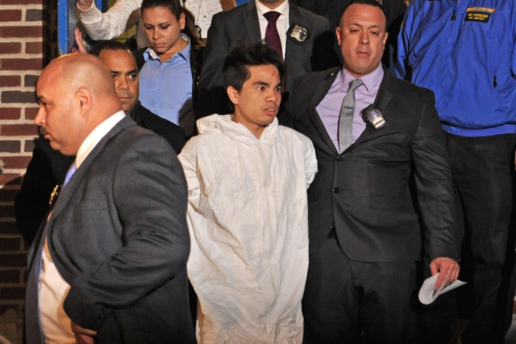 Chen Mingdong (left), a suspect in the murder of a mother and four children in Brooklyn, is escorted by police on Sunday. Photo: AP