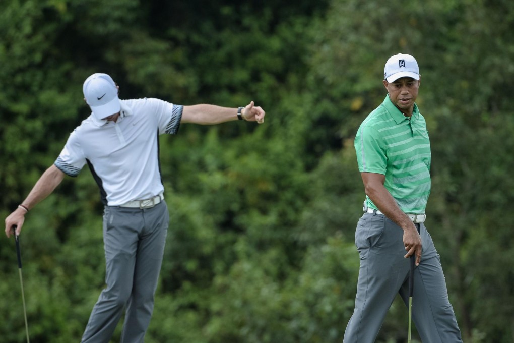 Rory McIlroy and Tiger Woods during their one-on-one exhibition game at Mission Hills in Haikou. With the pressure off, McIlroy had a rare victory. Photos: AFP
