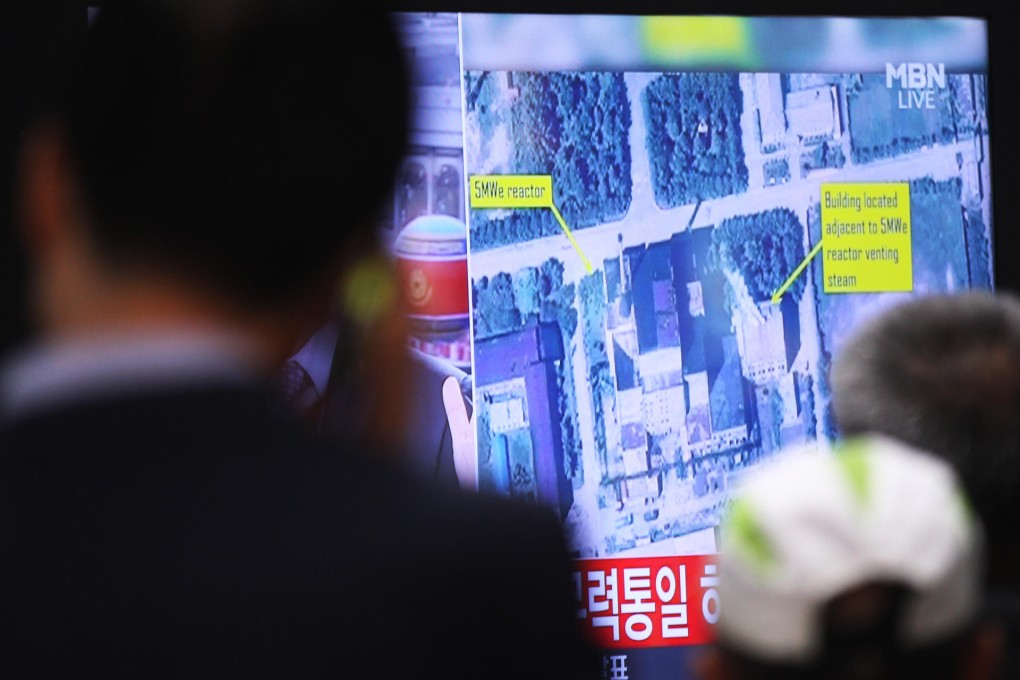 South Koreans watch a broadcast depicting satellite imagery of nuclear facility in North Korea, which has been expanding. Photo: AP