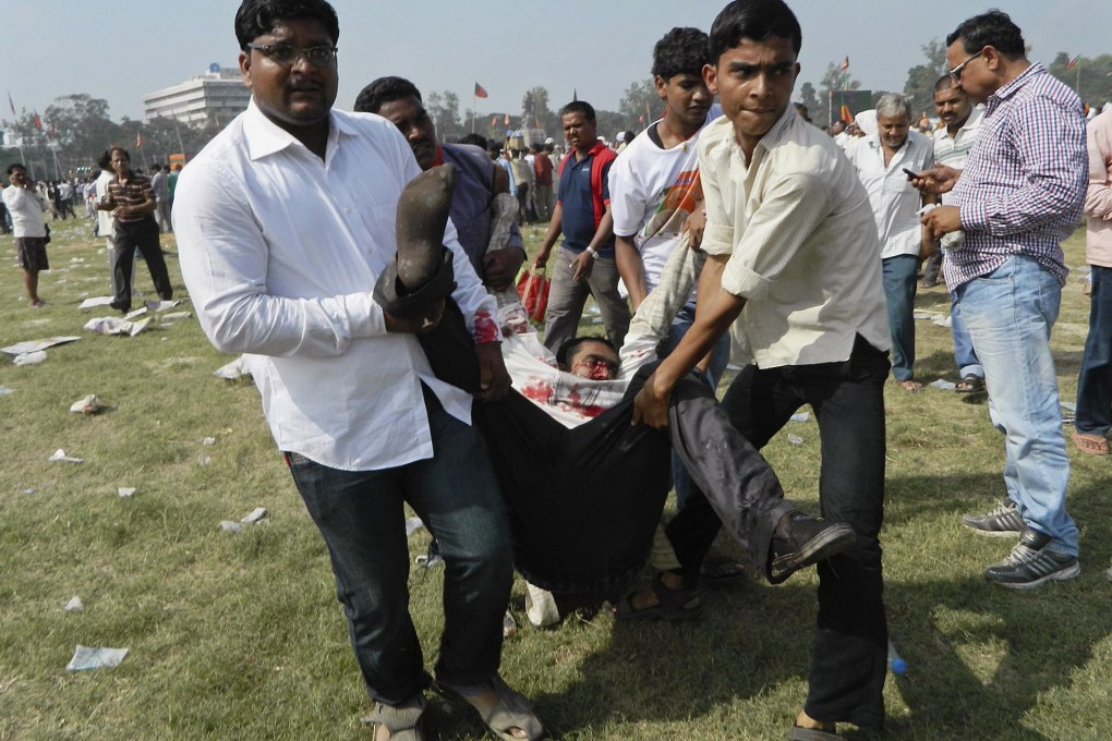 People carry an injured man after a bomb blast in Patna. Photo: reuters