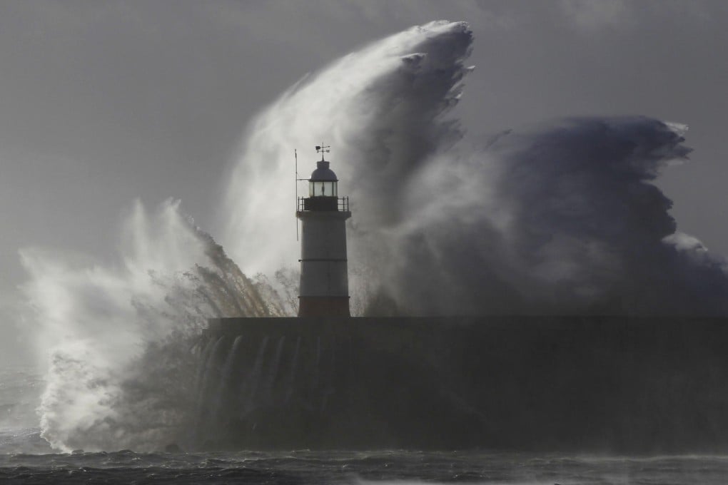 Waves crash against a lighthouse at Newhaven, East Sussex yesterday, near to where a 14-year-old boy was swept away to sea. Photo: Reuters