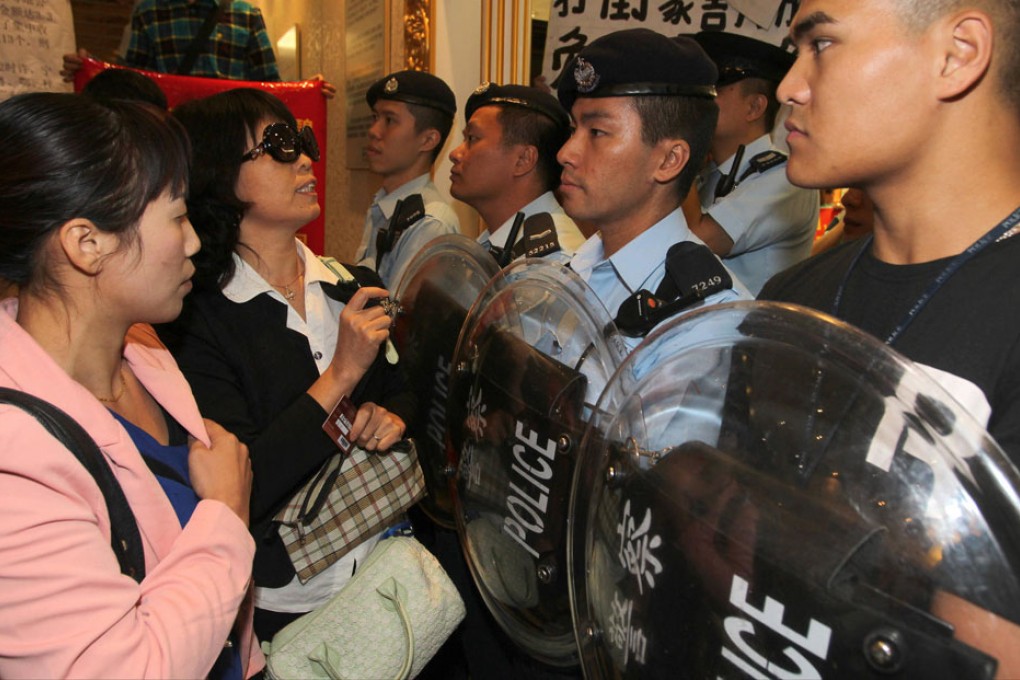 Slogan-shouting protesters come face to face with police at DCHL in Causeway Bay. Photo: Robert Ng
