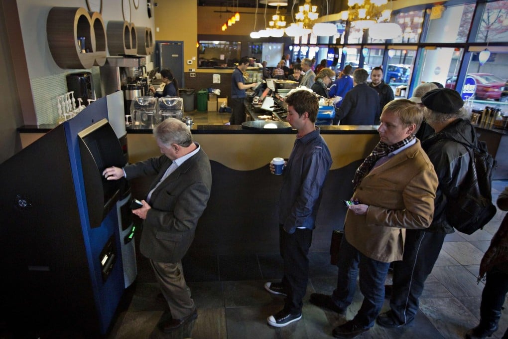 Users queue at a bitcoin ATM in Vancouver. Photo: Reuters