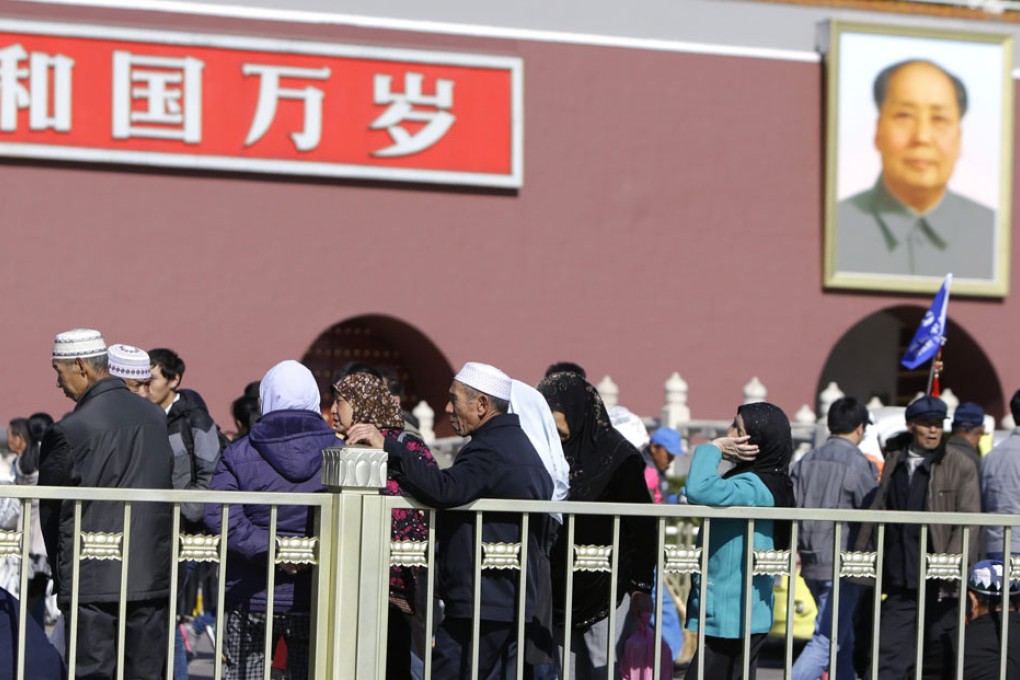 Tourists in front of the gate in Tiananmen Square yesterday,
the scene of Monday’s deadly jeep crash. Photo: Reuters