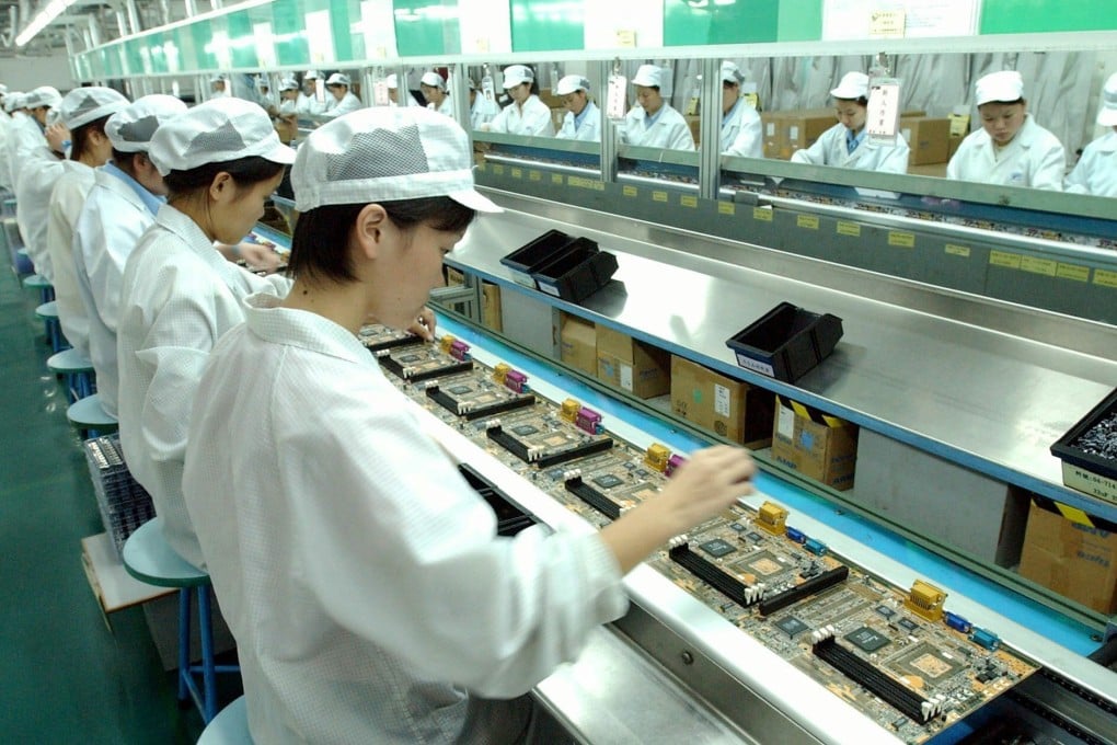 Workers on the factory line in an electronics factory in Shenzhen Photo: EPA