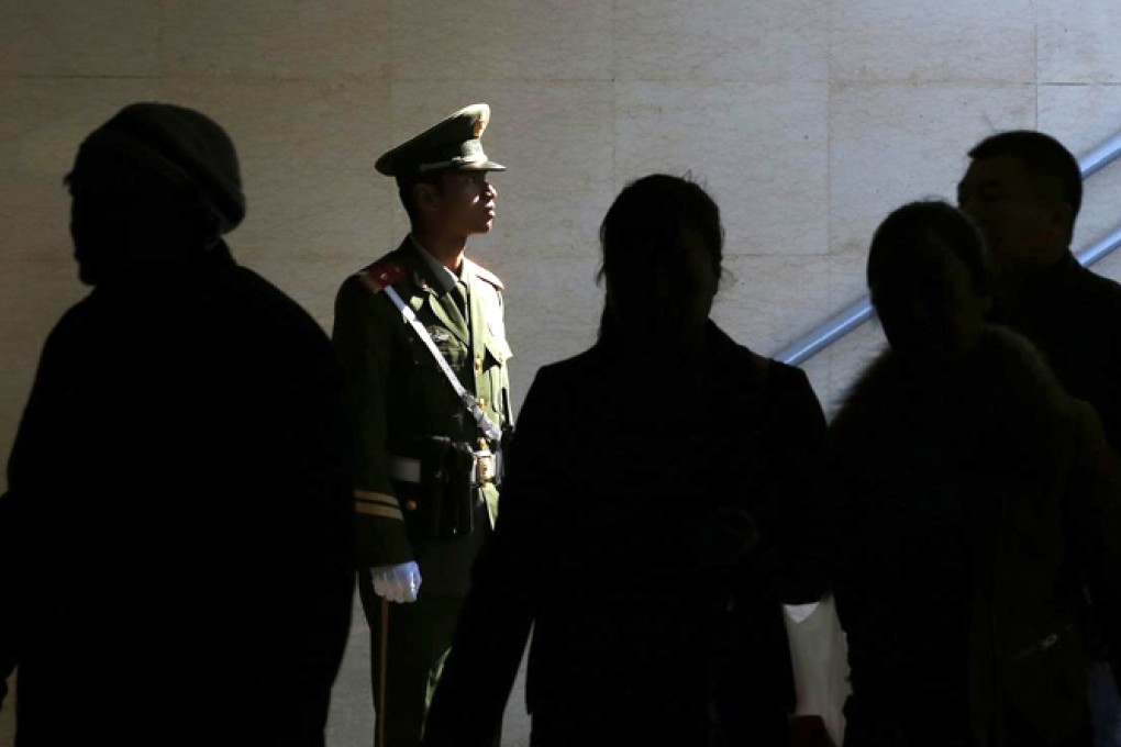 A policeman stands guard in a passageway connecting Tiananmen Square to the Forbidden City in Beijing. Photo: Reuters