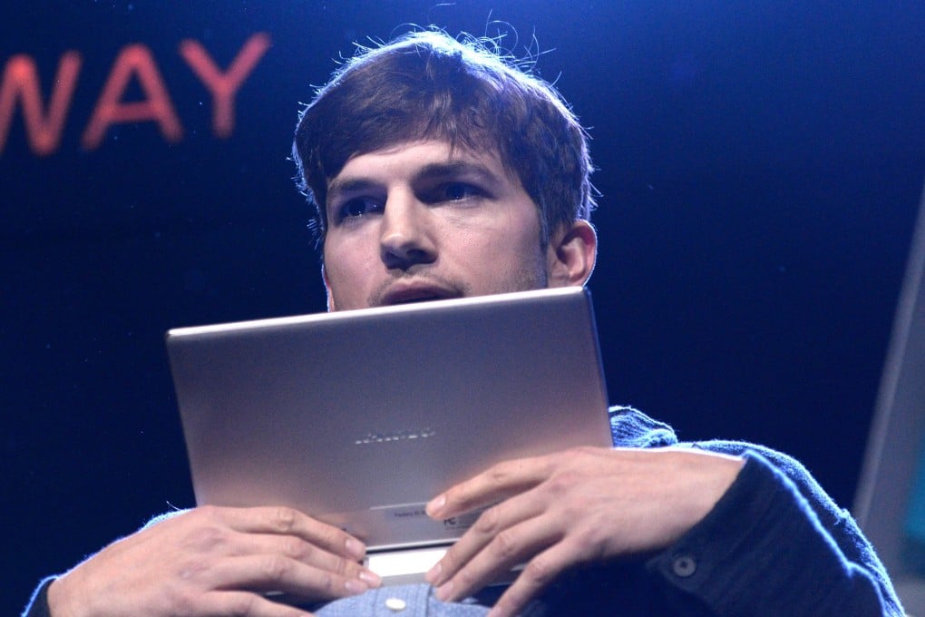 US actor Ashton Kutcher presents Lenovo's first multi mode tablet Yoga Tablet Photo: AFP