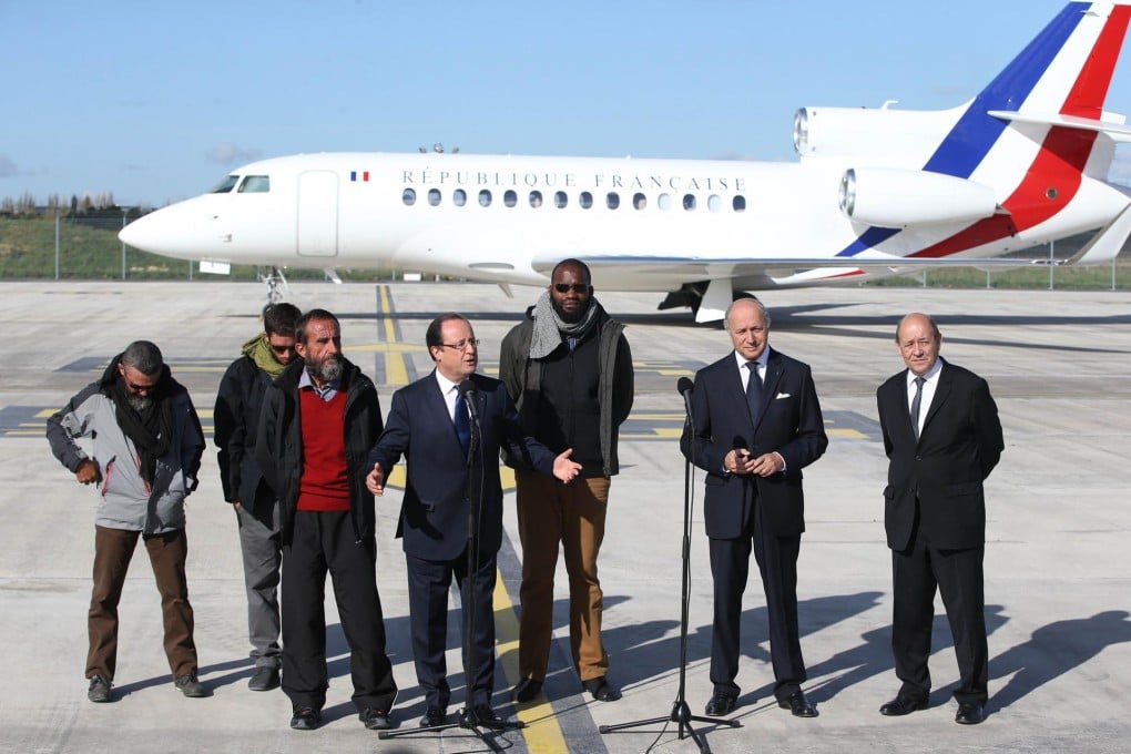 President Francois Hollande welcomes (from left) Marc Feret, Pierre Legrand, Daniel Larribe and Thierry Dol, with ministers Laurent Fabius and Jean-Yves Le Drian. Photo: AFP