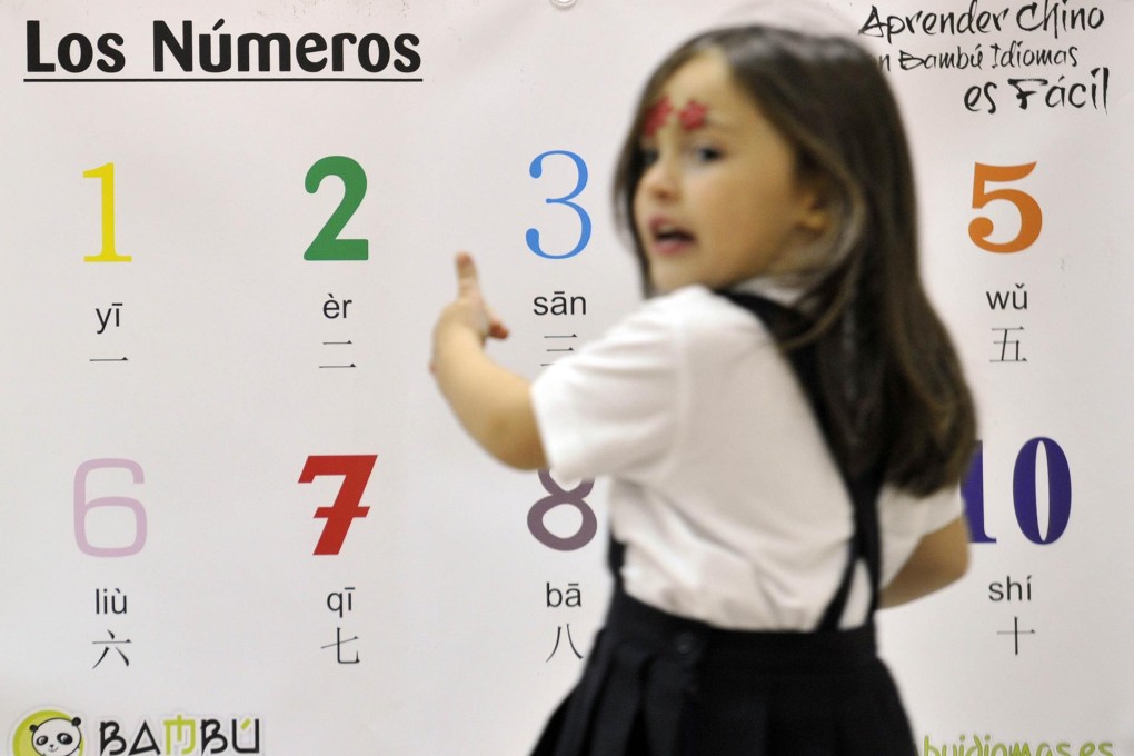Angela, aged 4, takes a Chinese lesson in Madrid. Numerous schools here have started holding such lessons. Photo: AFP