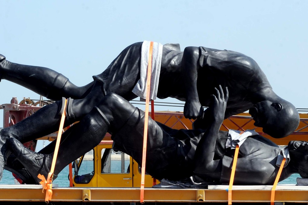 The bronze sculpture titled 'Coup de Tete' by Algerian-born French artist Adel Abdessemed is loaded on a lorry after it was removed from the Corniche in Doha. Photo: Reuters