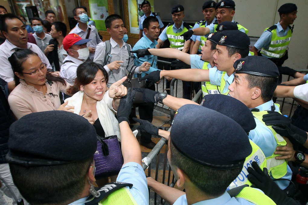 Police move in to end a five-day protest in which dozens of mainlanders had stormed the Causeway Bay sales centre of a firm running a controversial marketing system and demanded refunds. Photo: Jonathan Wong