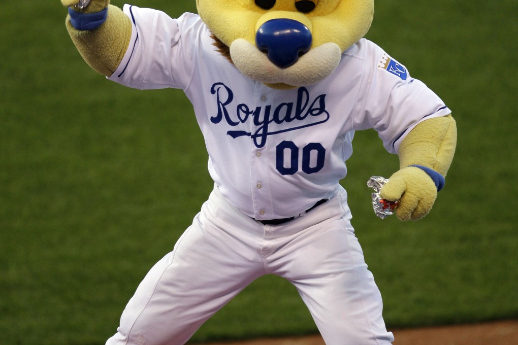 Kansas City Royals mascot "Sluggerrr" throws hot dogs into the crowd during a game. Photo: AP