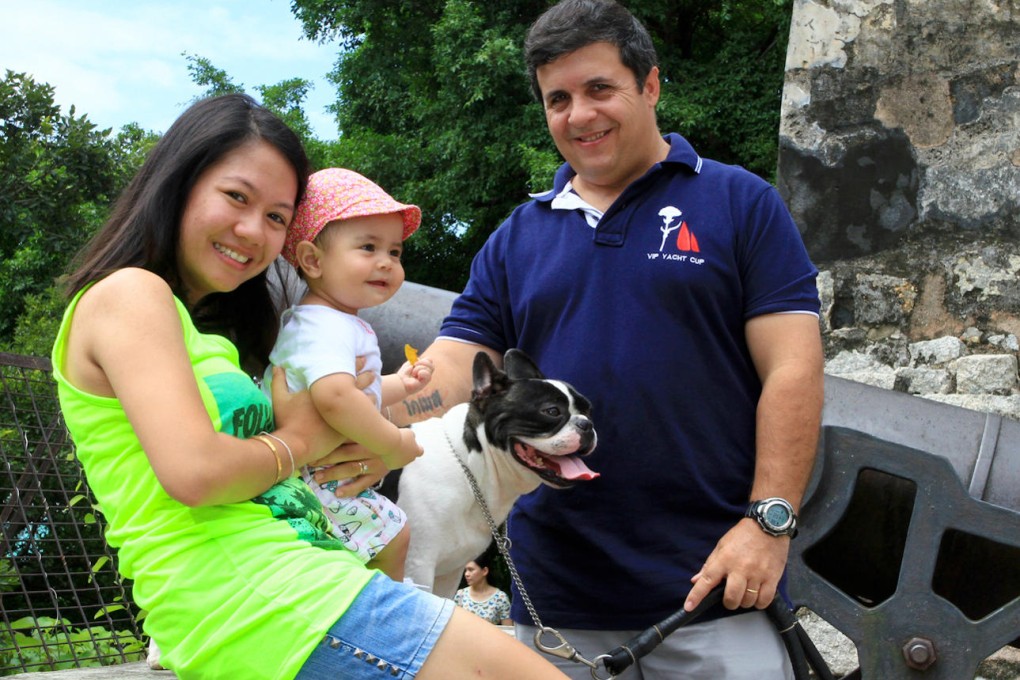 (From left) Nae Gomes, one-year-old Maria Gomes, pet bulldog Noel and Joao Gomes.