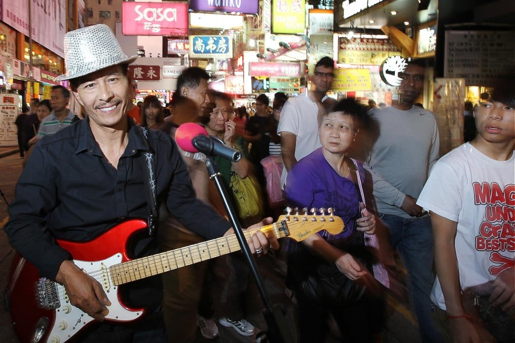 Lam Fat loves singing with his band 3L in Mong Kok's pedestrian area. But people living nearby say street performers are making the area chaotic. Photo: Sam Tsang