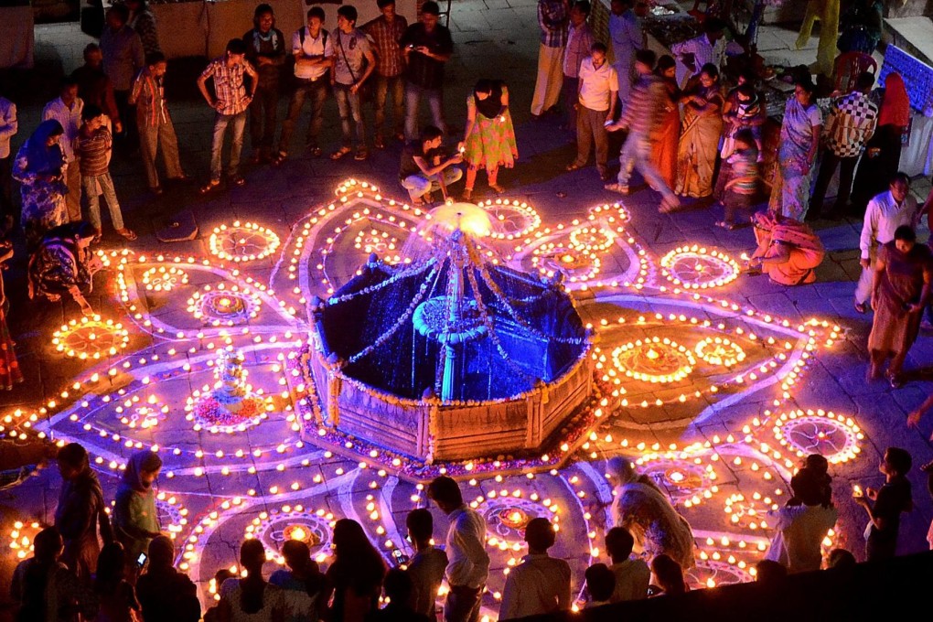 Hindu devotees light oil lamps for the festival at Gohar Mahal. Photo: EPA