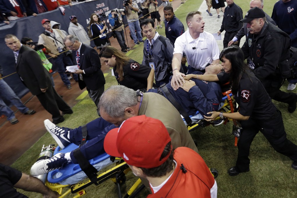 Houston Texans head coach Gary Kubiak is taken off the field on a stretcher. Photo: AP