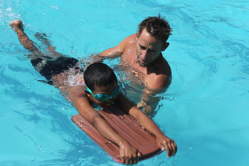 More Than Sport volunteer Jonathan Story leads a swimming class in Bali