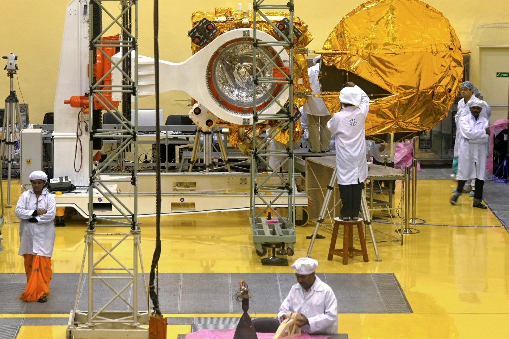 Scientists and engineers prepare India's space orbiter. Photo: AFP