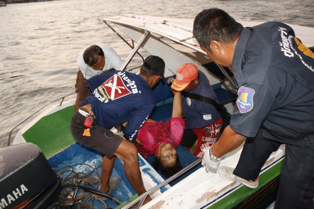 An injured tourist is being cared for as she is rescued from the sea by Thai rescue officers after a boat accident in Pattaya. Photo: AP