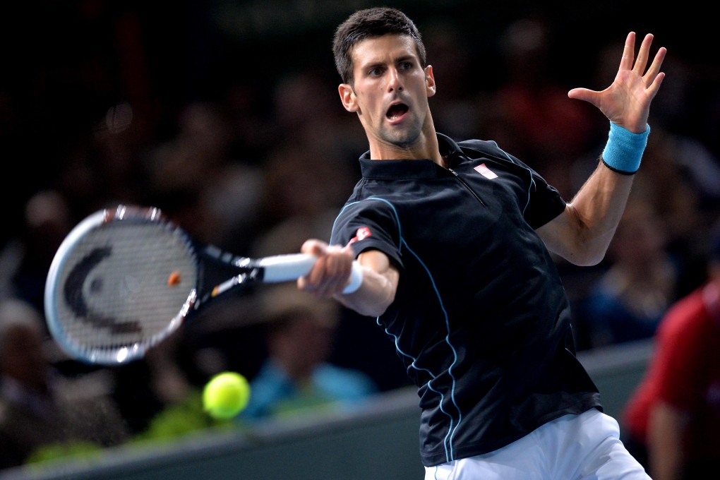 Novak Djokovic hits a return against David Ferrer. Photo: Xinhua