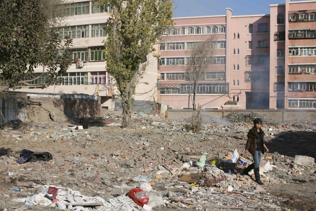 A woman collects waste at a garbage dump site in Urumqi in Xinjiang. Photo: Reuters