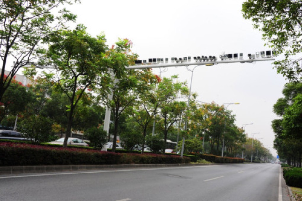 Photos show a structure with two arms stretching across each side of the road covered with surveillance devices. Photo: Xinhua