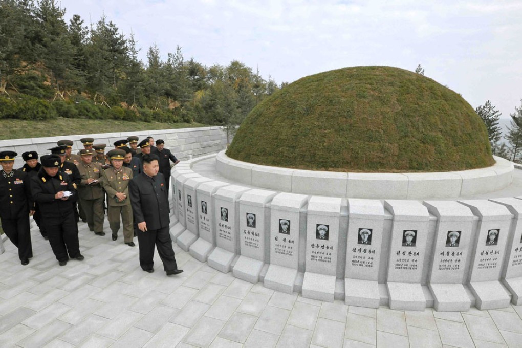Kim Jong-un (right) visits the cemetery of fallen fighters at an undisclosed location in North Korea. Photo: AFP