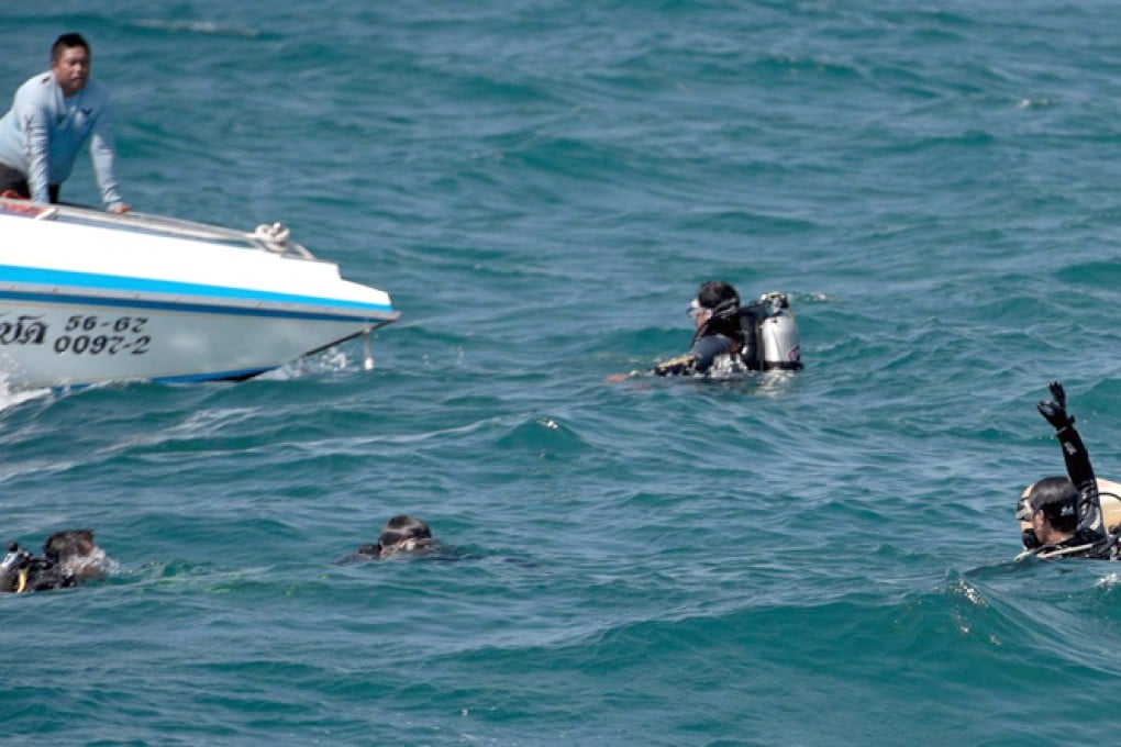Thai rescue divers search the waters where a double-decker tourist ferry sank near Koh Larn island off Pattaya. Photo: AFP