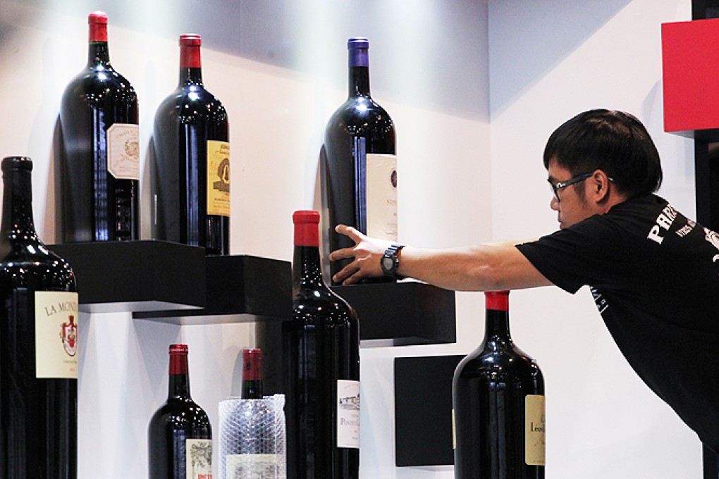 An exhibitor sets up a booth at the sixth Hong Kong International Wine and Spirits Fair, at the Hong Kong Convention and Exhibition Centre in Wan Chai. Photo: Nora Tam