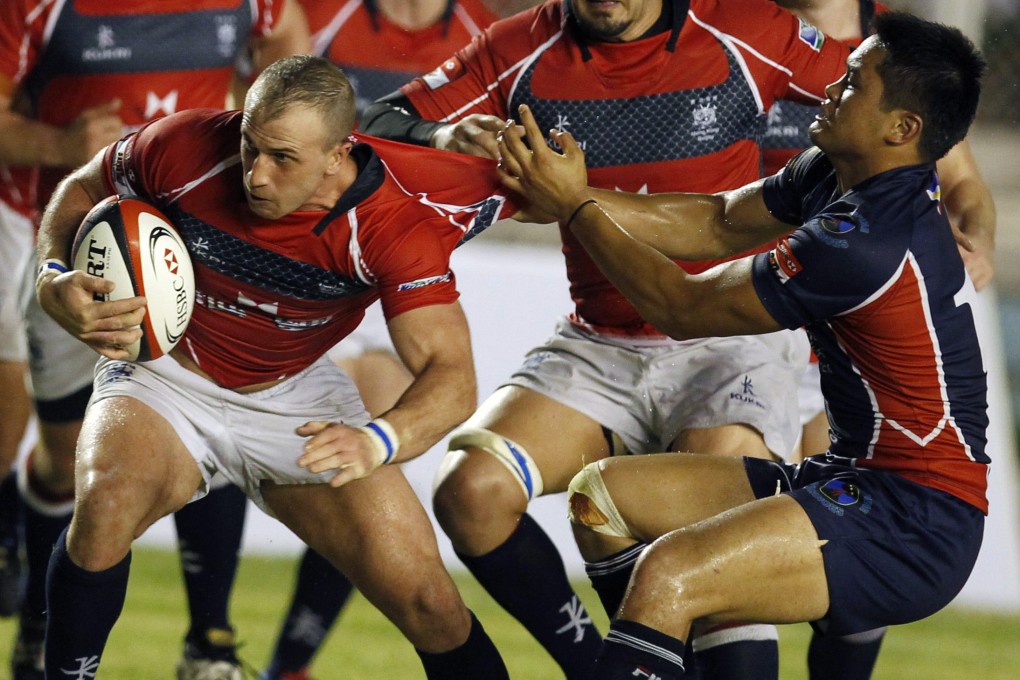 Hong Kong's Steve Nolan (left) tries to break through against the Philippines in an Asian Five Nations match in Manila. Photo: SCMP Pictures