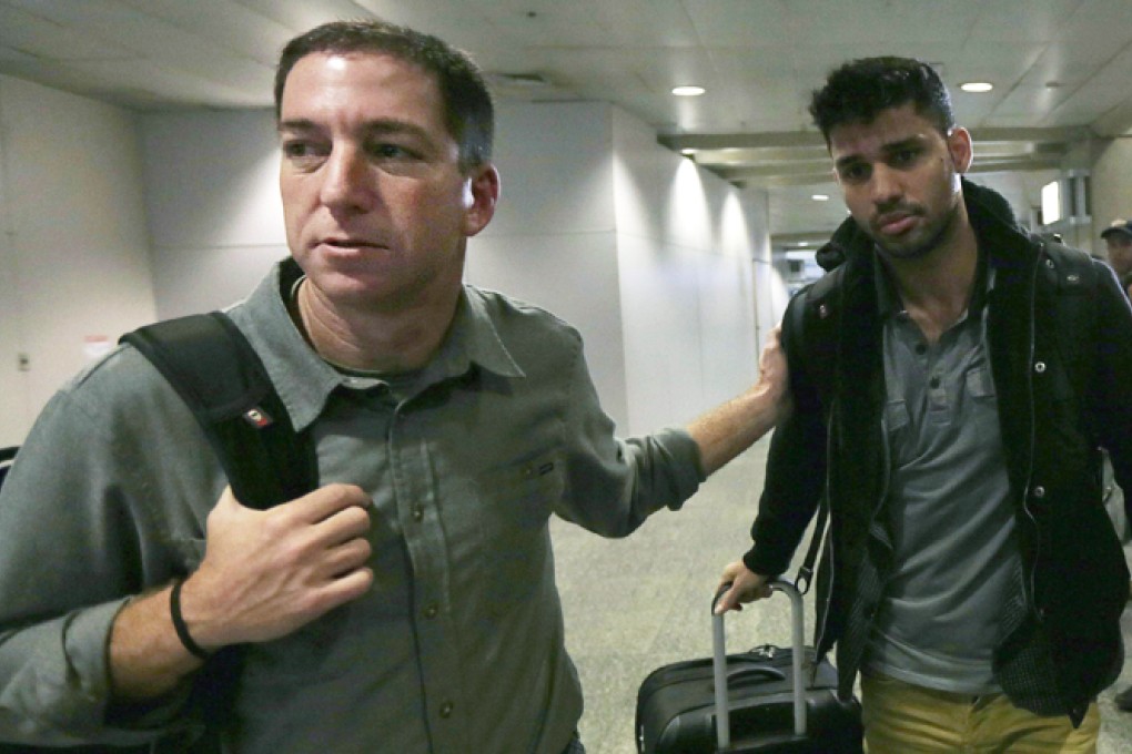 US journalist Glenn Greenwald walks with his partner David Miranda in Rio de Janeiro's International Airport. Photo: Reuters
