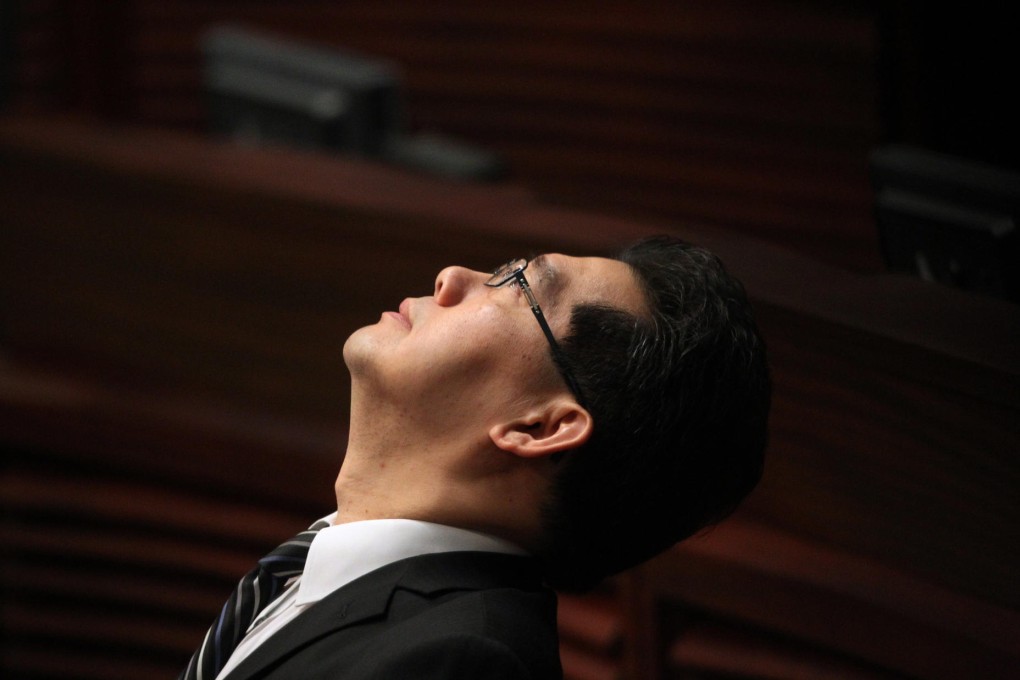 Commerce and economic development secretary Greg So has a lot on his mind during yesterday's Legco vote meeting. Photo: Felix Wong