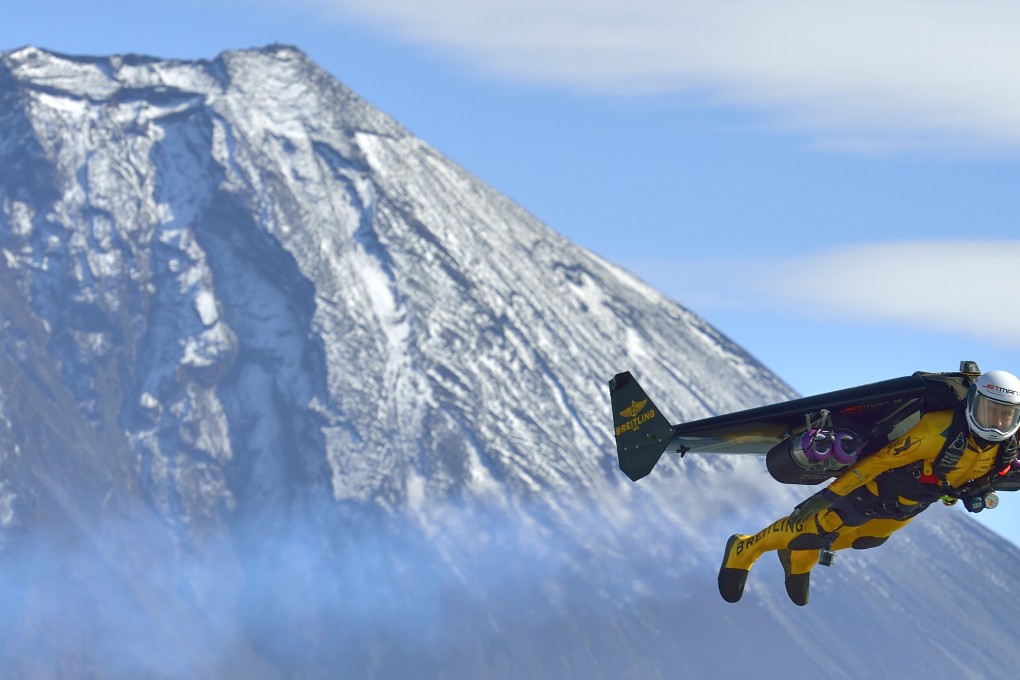 Yves Rossy, known as the Jetman, flies in front of Mount Fuji. Photo: Reuters