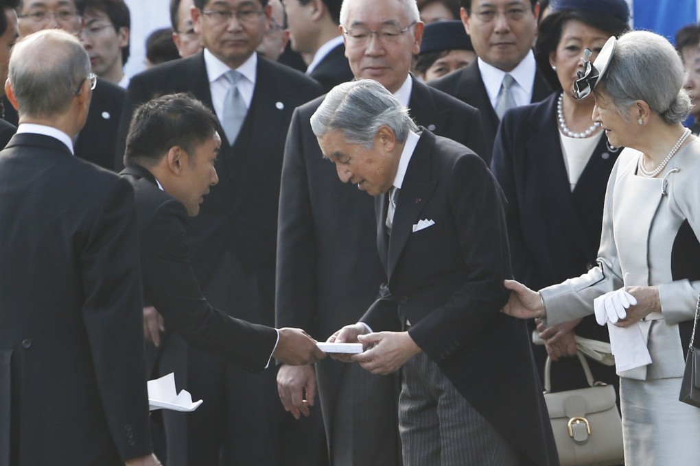 Actor-turned-lawmaker Taro Yamamoto, second left, hands over a letter to Japan's Emperor Akihito, second right. Photo: AP