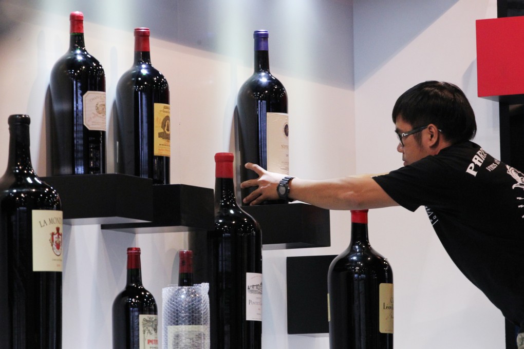 An exhibitor sets up their booth at the Hong Kong International Wine and Spirits Fair, at the Hong Kong Convention and Exhibition Centre in Wan Chai. Photo: Nora Tam