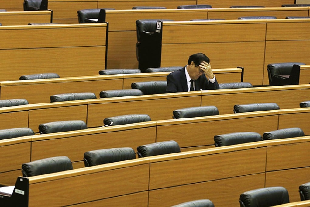 A Thai senator waits for other members who mostly vowed to boycott a meeting to deliberate the controversial amnesty bill at parliament in Bangkok, Thailand, on Friday. Photo: EPA